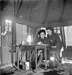 Nursing Sisters Eloise MacDiarmid and Frances Caddy on night duty, No.1 Canadian General Hospital, Royal Canadian Army Medical Corps (R.C.A.M.C.), Andria, Italy, February 1944 February 1944.