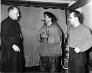 Fathers Treboal and Paradis, R.C. Mission House, with Inuit man 1953