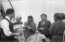 Inuit women with a non-Inuit man aboard R.M.S. Nascopie 1946