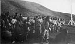 Inuit listening to Hon. Louis A. Rivet, the presiding magistrate in the "Rex v. Nookudlah, Oorooeungnak and Ahteetah [Nuqallaq, Ululijarnaat and Aatitaaq]" murder trial 30 August 1923