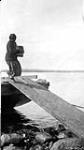 [Inuk woman discharging freight] Original title: Eskimo woman discharging freight 1927
