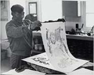 Cape Dorset man pulling print of Kiakshuk's drawing, "Strange Scene" November 1965.