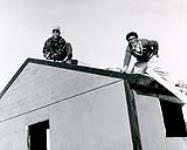 Joannie and boy fixing roof, Resolute Bay n.d.