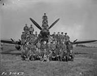 [R.C.A.F. 440 Squadron members pose with a Hawker Typhoon in Normandy, France] August 1944.