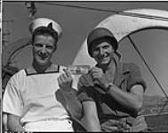 Left to right, A/B Bill Kirk, Cedar Rapids, Iowa, U.S.A.; Sgt. Samuel Finn of St. Louis Mo. U.S.A August 22, 1944.