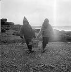 [Sarpinak and Mosha Michael carrying a bucket] [between 1956-1960]