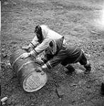 [Two men rolling a barrel] [between 1956-1960]