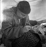 [Woman sewing inside a tent] [between 1956-1960]