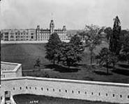 Mackenzie Building at the Royal Military College (RMC), Kingston, Ontario with Fort Frederick in the foreground [between 1940 and 1970].