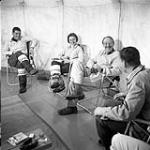 [Group of people socializing in a tent] [between 1956-1960]