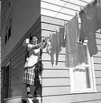 [Woman hanging clothes, Kinngait, Nunavut] 1960