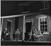 Farming Ontario, the Morans gather on the porch after a day's work well done 1942