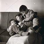 [Sam and John Houston playing with family friend Mackituk] [between 1956-1960]