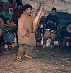 Man playing a drum. Pelly Bay, Nunavut 1961.