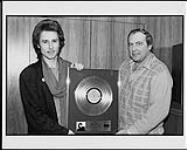 John Waite is presented Gold and Platinum by Capitol-EMI for his album "No Brakes" and single "Missing You" [ca 1984].
