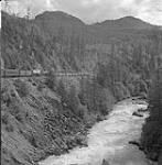 View of the Pacific Great Eastern train and River, BC Aug [19-25] 1954.