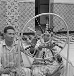 A young man uses a beaded wheel in rehabilitation 1960