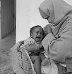 A woman comforts her child 1960