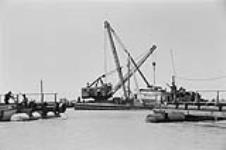 [Dredging equipment, the end of a dock and some boats on the St. Clair River] [between 1960-1962]