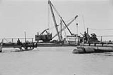[Dredging equipment, the end of a dock and some boats on the St. Clair River] [between 1960-1962]