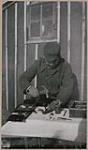 [Levi Joe, a silversmith, making drops for earrings] 1912