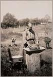 [Mrs. Peter John sifting meal] 1913