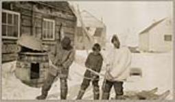[Three Inuit boys with bows and arrows] [between 1921-1922]