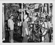 Seamen stand by throttles in engine room - HMCS NOOTKA 8 Dec. 1950.
