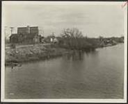 [View of Echo Drive on east side of canal showing Church of the Ascension and St. Patricks College] circa 1927-1930.