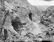 German trenches demolished by artillery, showing German dead. July, 1916. July, 1916