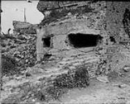 German machine gun emplacement in corner of house. Six feet of concrete still remains though hit by shells. June, 1917. June, 1917.