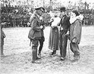 Canon Scott being introduced to 'Dolly' Charlie and friend at 1st Canadian Division Sports Meet.  JUNE, 1918