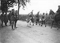 General Mewburn, Minister of Militia, interested in the Mascot of a Canadian Scottish Battalion. July, 1918. 1914-1919
