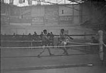 (Boxing) Gnr. Herskovitch (Canadian) defeating Sgt. Allison (Australian) in Heavy Weight Contest with Victors, "Corps Sports," Brussels. March 1919. 1914-1919