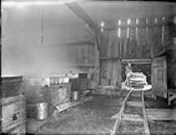 Interior of Small Bros. Maple Sugar camp, showing track in the evaporation station. 1880's