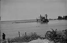 Dredge, Lake Winnipeg - dredging off Launching ways, Victoria Beach, [Man.] 1925