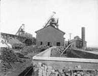 Atikokan Iron Works showing products on left. Bars of pig iron. Port Arthur, [Ont.].