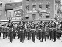 [The Governor General's Foot Guards fire the salute at the funeral procession of Lt. J. Thad Johnson] 3 July 1927
