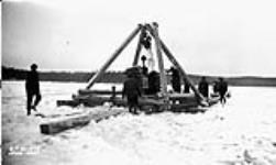 (Relief Projects - No. 51). Pulling the tractor out of the water. Feb. 1935