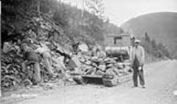 (Relief Projects - No. 61). Widening the road in the rock. Aug. 1933