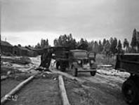 (Relief Projects - No. 154). Loading dismantled huts. Nov. 1935