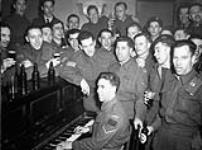 Personnel of The Royal Canadian Army Service Corps (R.C.A.S.C.) and Canadian Armoured Corps (C.A.C.) attending a Flin Flon Reunion at the Beaver Club, London, England, 20 February 1943. February 20, 1943.