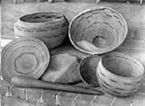 Pomo baskets, mortas and pestle.  [California]. 1924