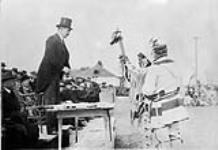 Chief Gun presenting pipe of Peace to Sir Robert Kindersley. 250th Anniversary Celebration of Hudson Bay Co. [Edmonton], Alta. 1920