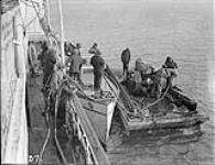 (Hudson Strait Expedition) Cletrac tractor going ashore from C.G.S. Stanley at Base 'B' Aug 1927