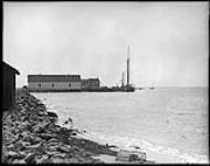 Wharf at Entry Island, Magdalen Islands, P.Q., [Lobster trap in foreground.]. n.d.