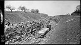 Train in cut near Thorold, (Ont., during the construction of the new) Welland Canal. 17 Apr. 1914