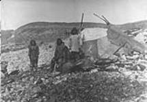 [Inuit family standing by a tupiq]. Original title: Eskimo Igloo  [ca. 1903].