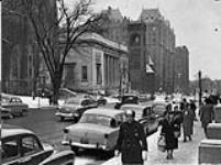 Street scene showing people and the Museum of Fine Arts (centre) on Sherbrooke Street ca. 1953
