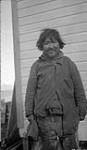 Inuit man. [Alianakuluk Panigusiq Juujjak. This photograph was taken behind the Pond Inlet R.C.M.P Detachment.]. August 1923.